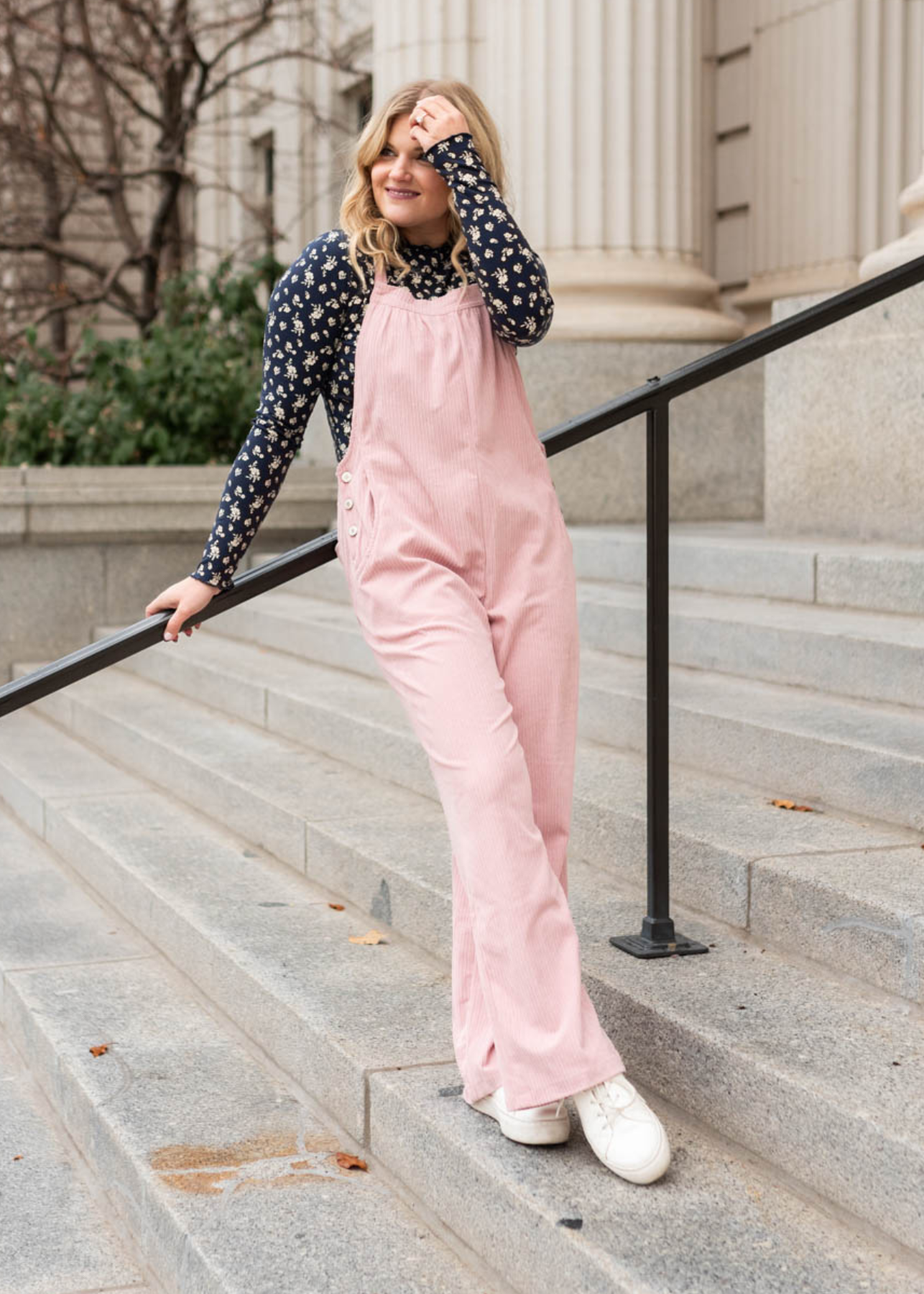 Front view of dusty pink corduroy overalls with straight legs