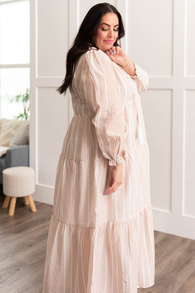 Side view of a plus size tan patterned dress