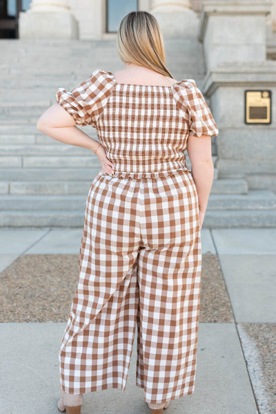 Back view of the plus size taupe gingham jumpsuit