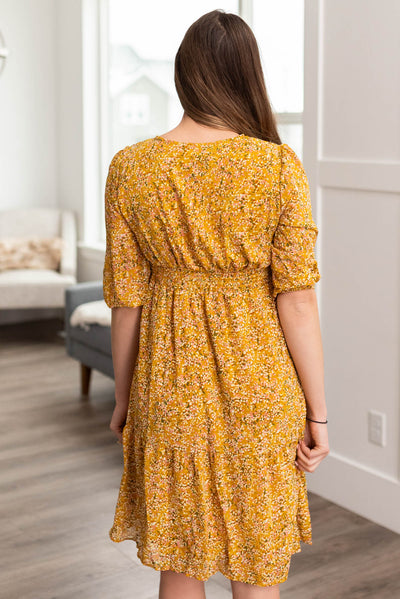 Back view of a mustard floral dress