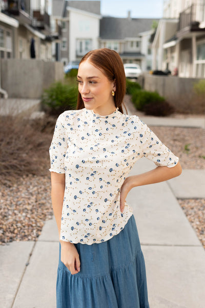 Front view of the cream floral top