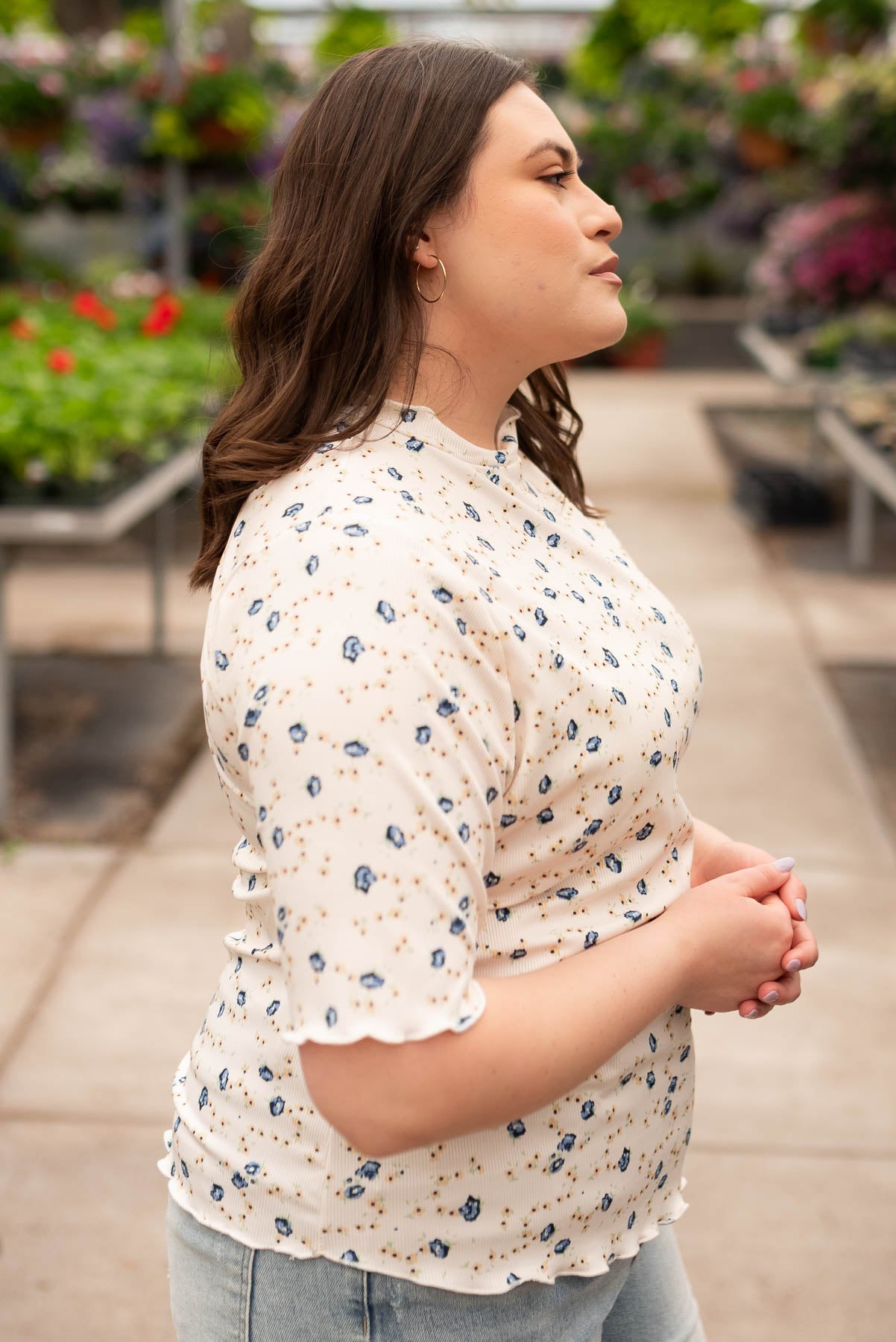 Side view of the plus size cream floral top