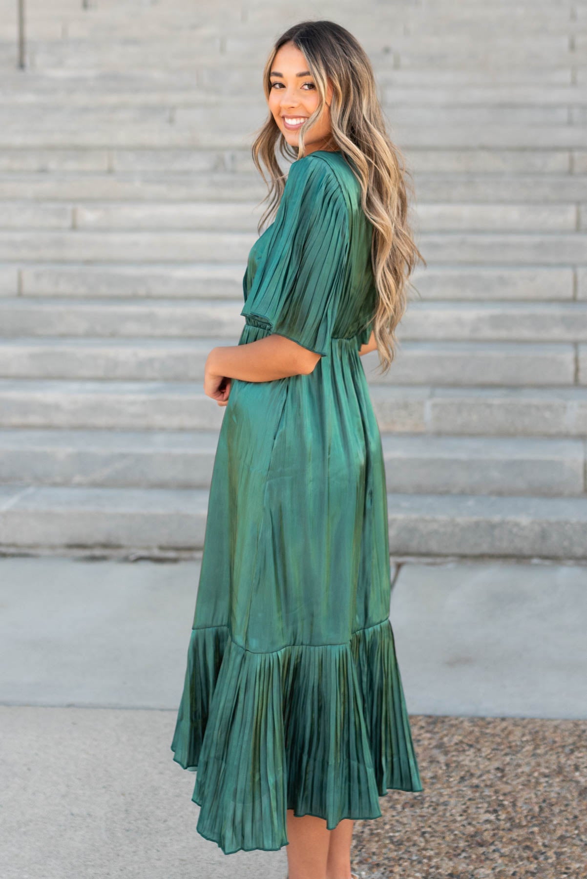 Pleated sleeves on the hunter green pleated wrap dress