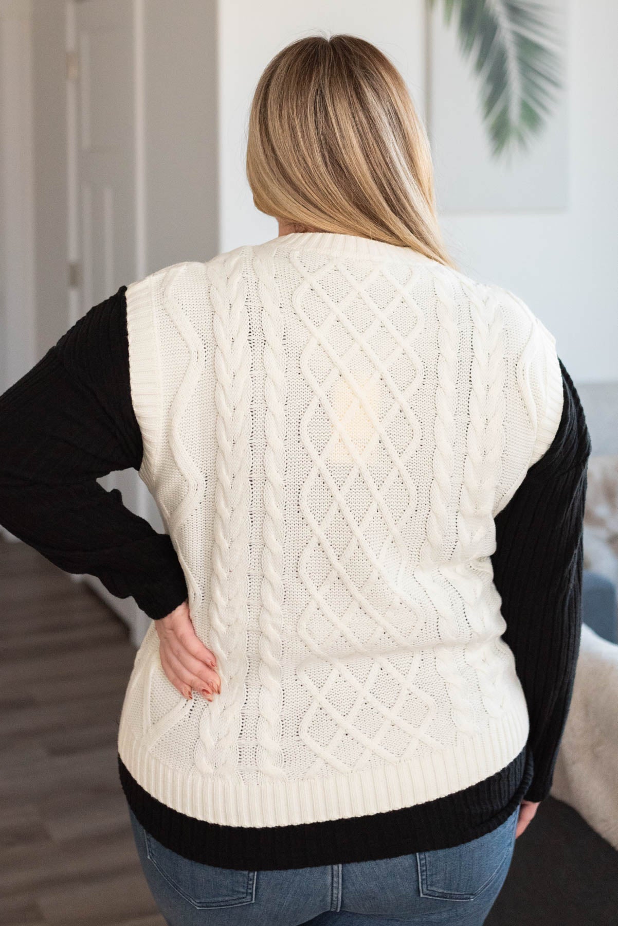 Back view of a ivory sweater vest