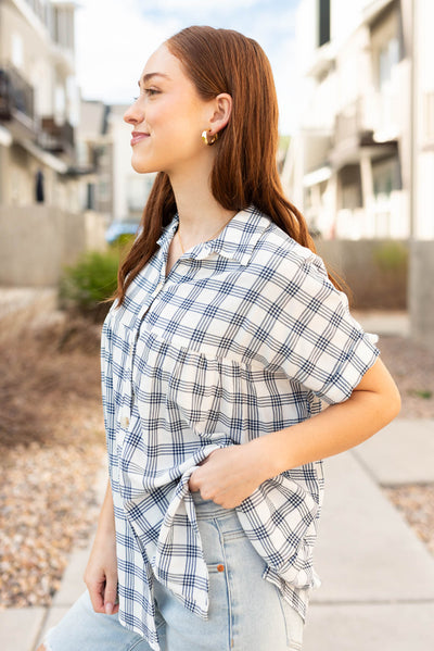 Side view of the navy button down top