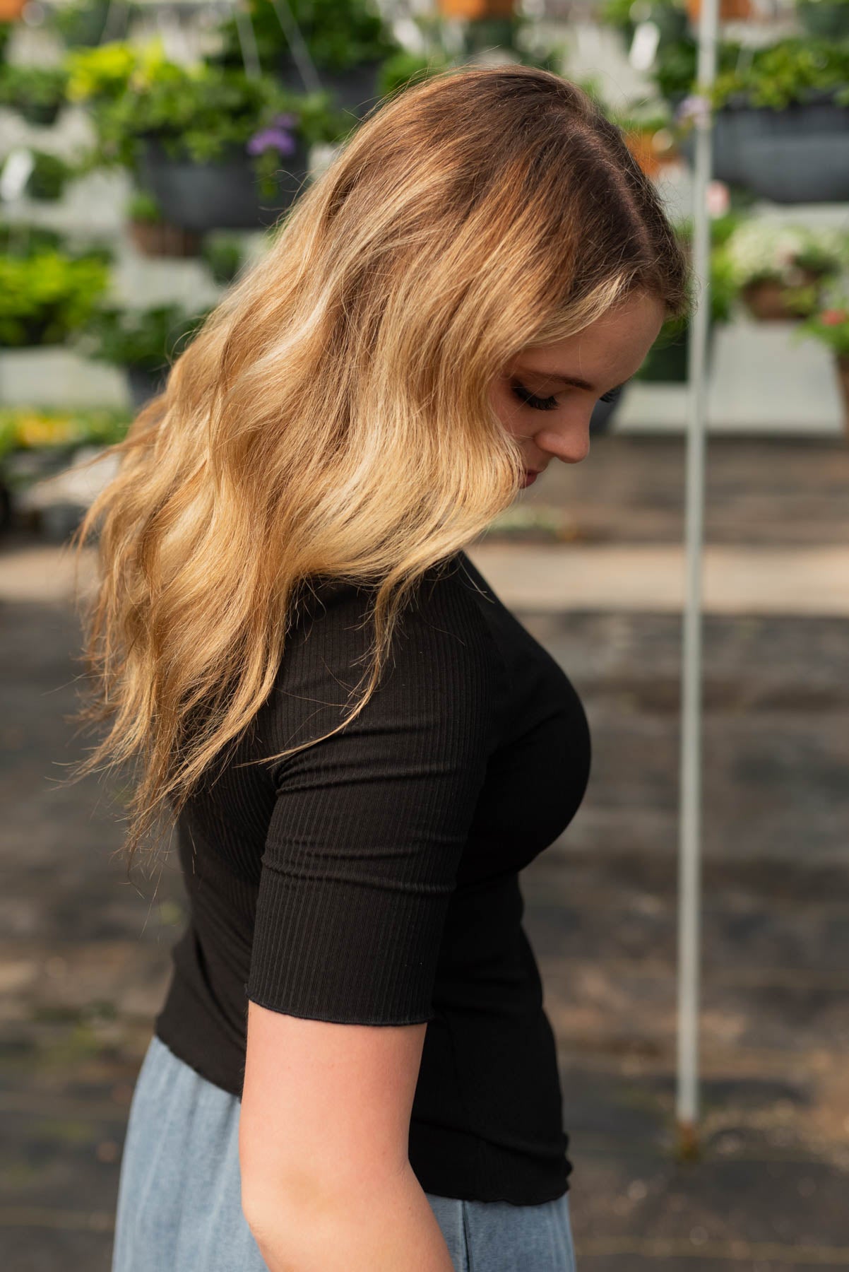 Side view of the black textured knit top