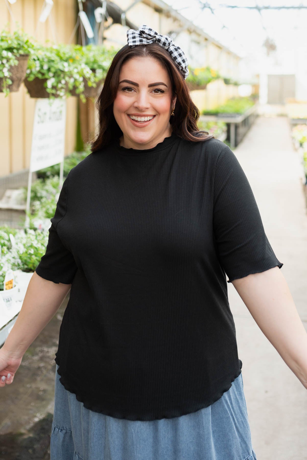 Plus size black textured knit top with short sleeves