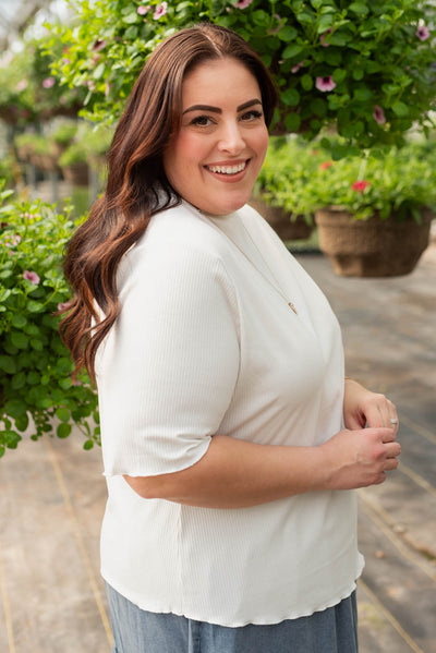Side view of the plus size ivory textured knit top