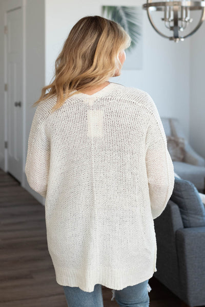 Back view of a off white cardigan
