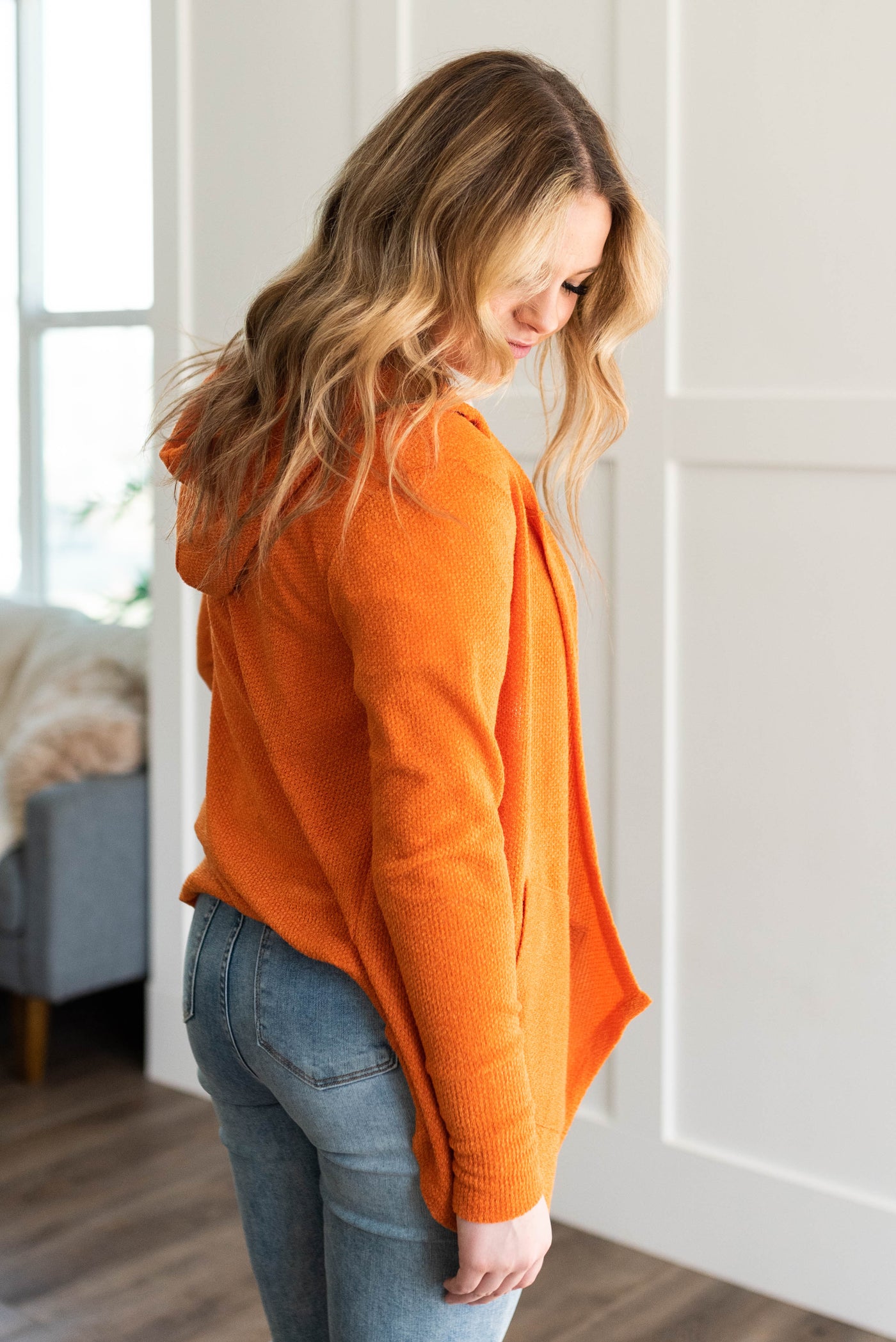 Side view of the apricot orange cardigan