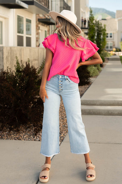 Light wide leg jeans that button up and have a frayed hem