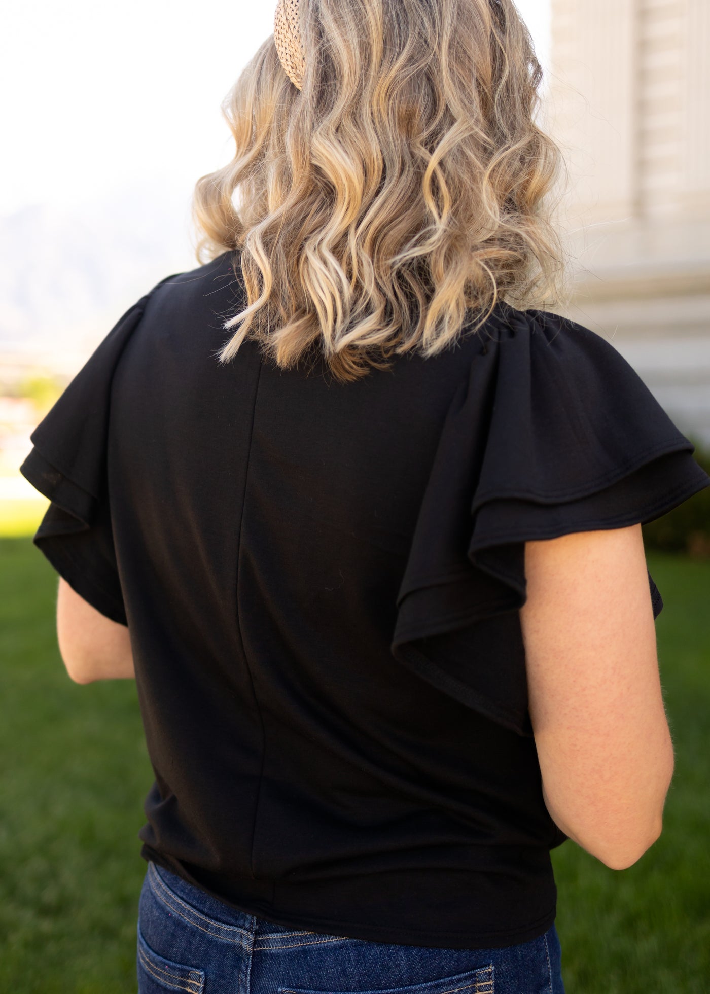 Back view of a short sleeve ruffle top