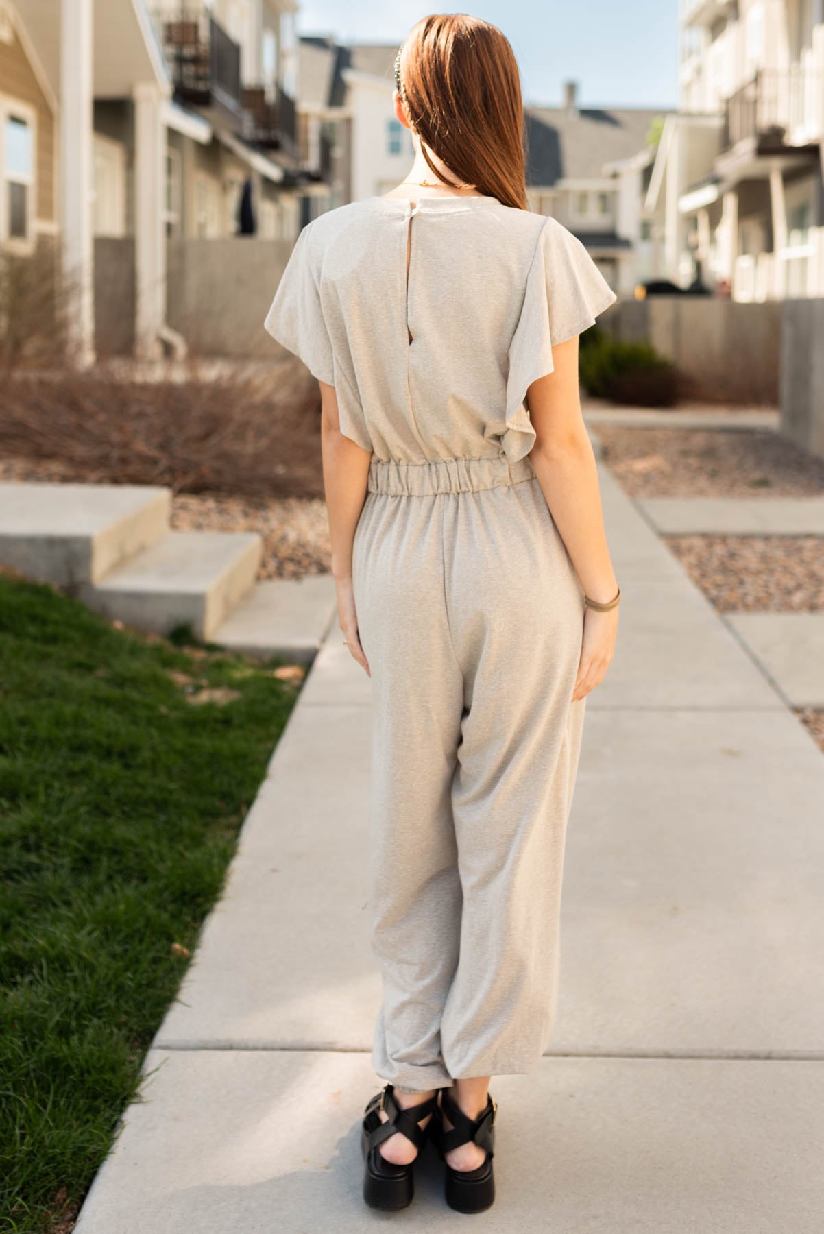 Back view of the taupe drawstring jumpsuit