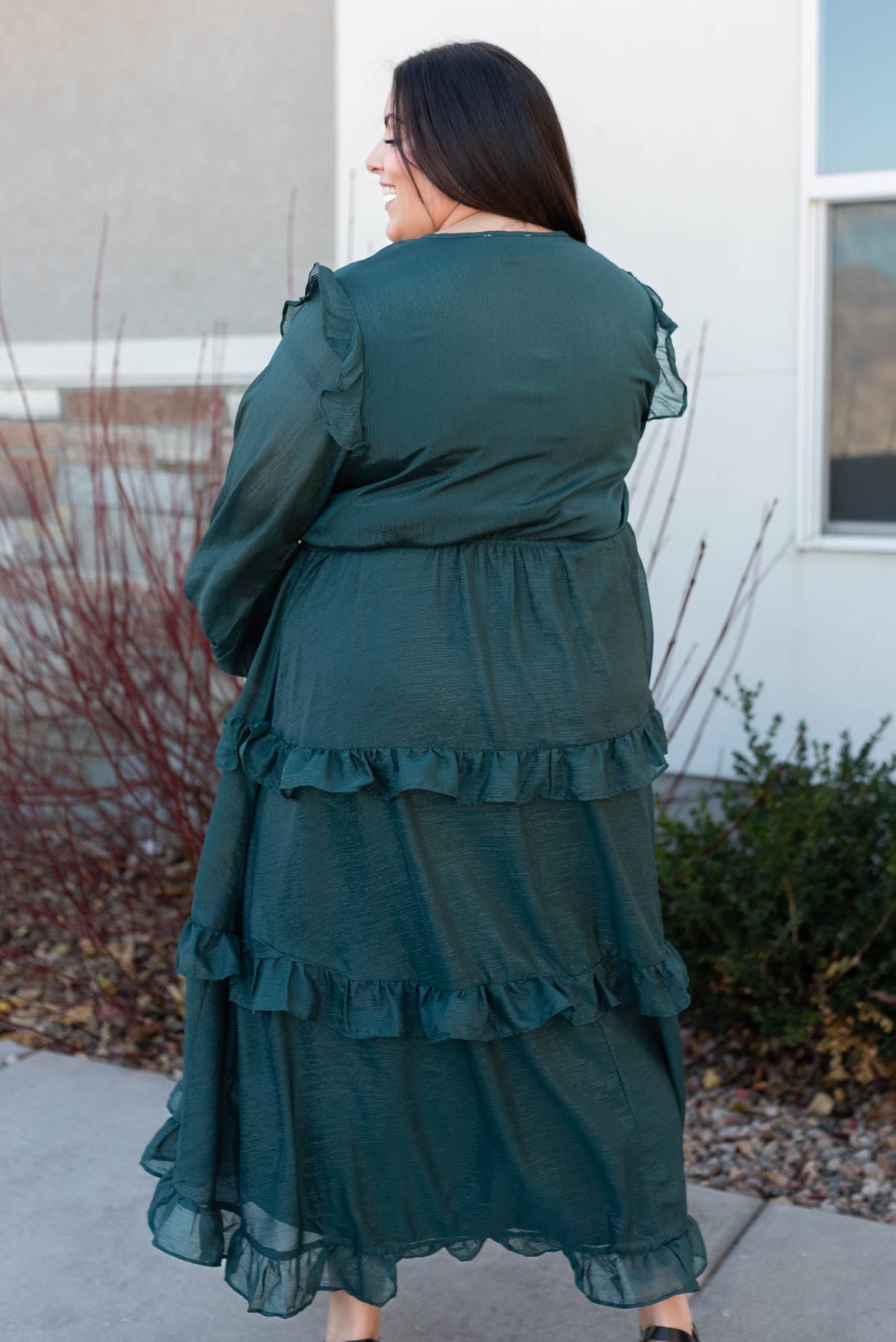 Back view of a plus size hunter green tiered dress