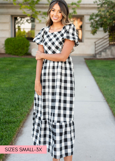 Front view of a black gingham dress with short sleeves