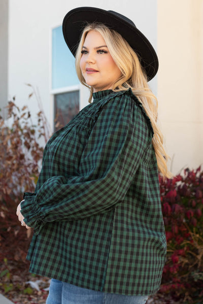 Side view of a plus size gingham hunter green ruffle blouse