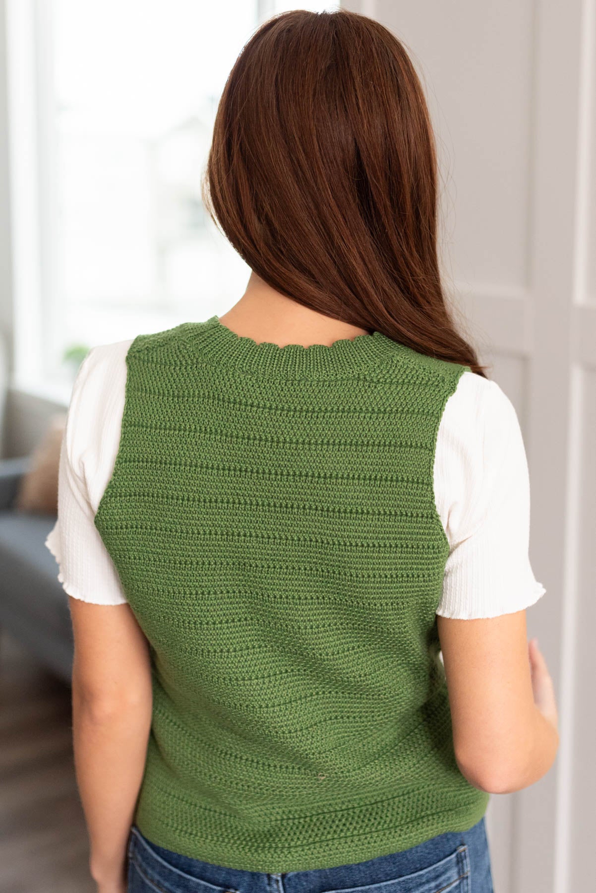 Back view of the green knitted sweater
