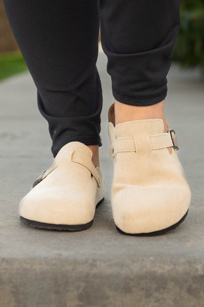 Front view of taupe slip on clogs