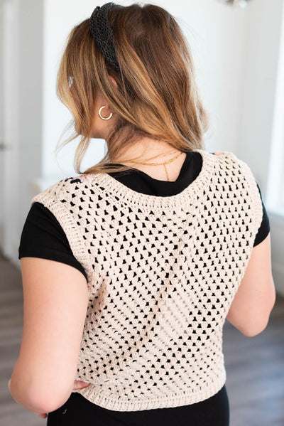 Back view of the beige crochet knit top