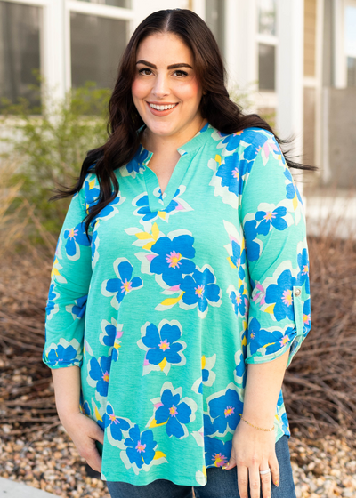 Front view of the plus size green floral top