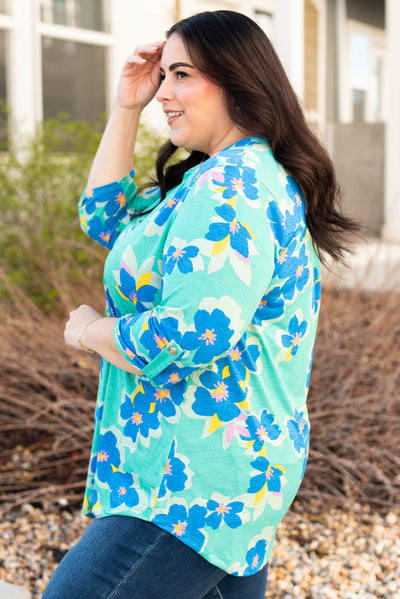 Side view of the plus size green floral top