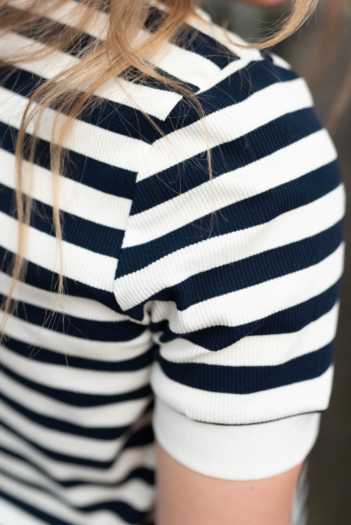 Close up of the sleeve on a navy stripe top