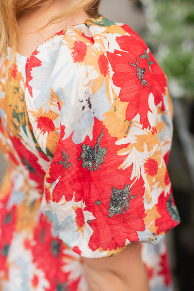 Close up of the fabric on the sleeve of the plus size red floral dress