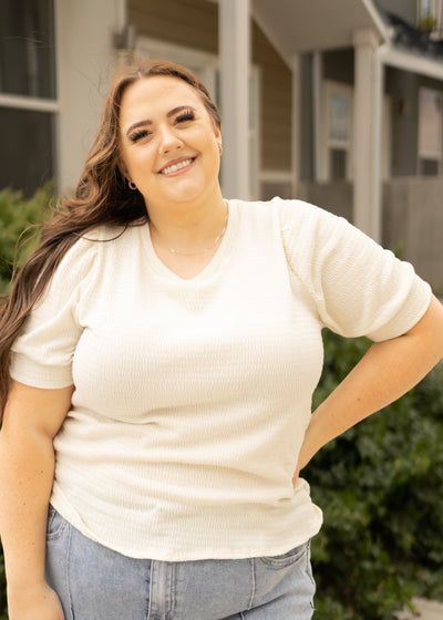Plus size short sleeve cream top with textured knit fabric