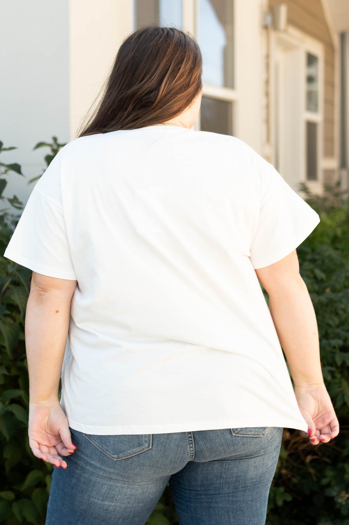 Back view of the plus size stay wild and free ivory tee