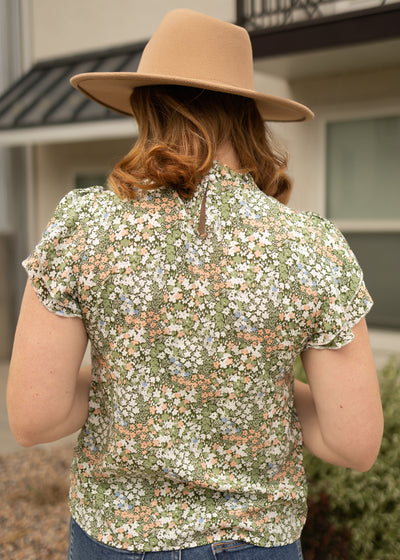 Back view of a green floral top