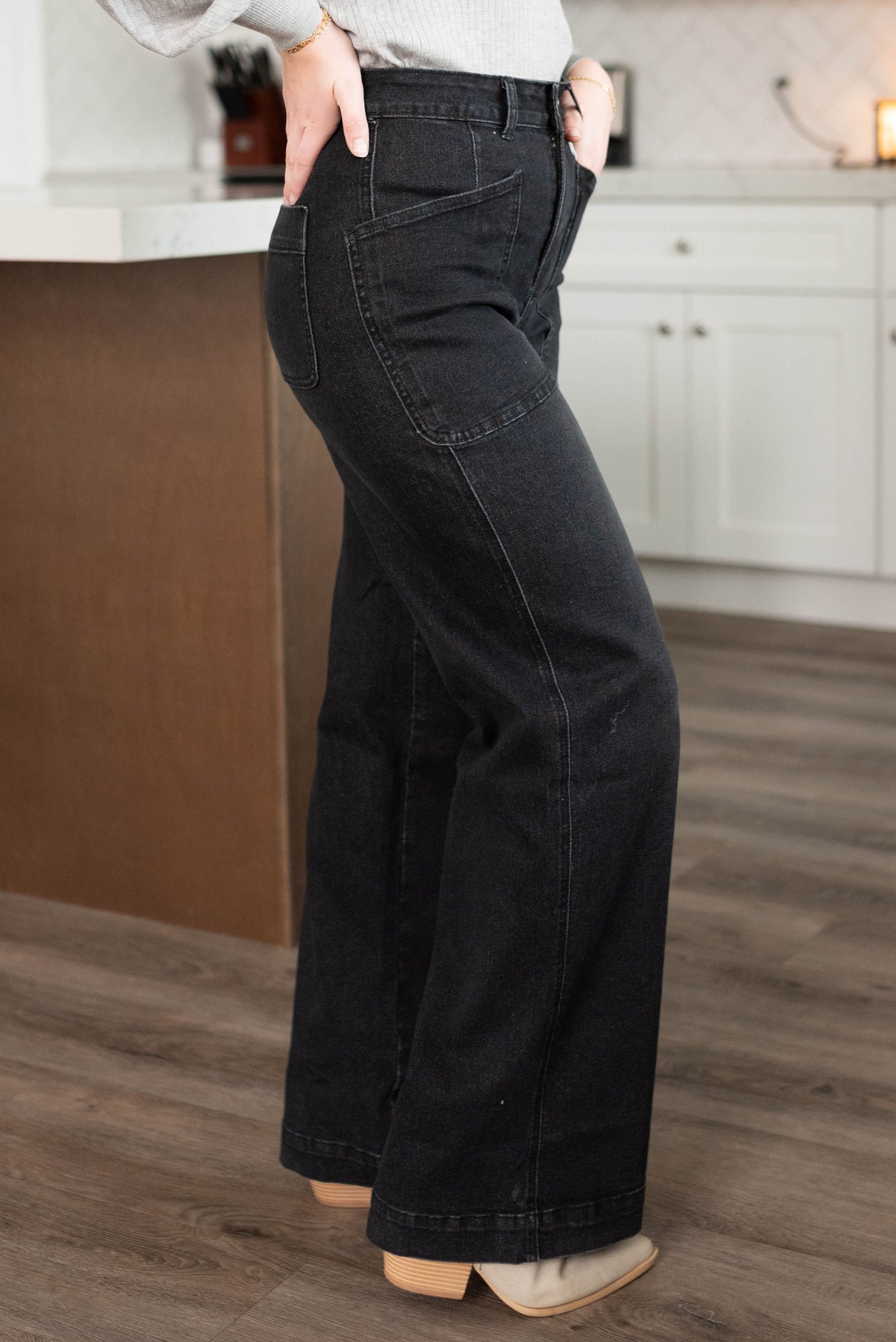 Side view of black denim wide leg pants