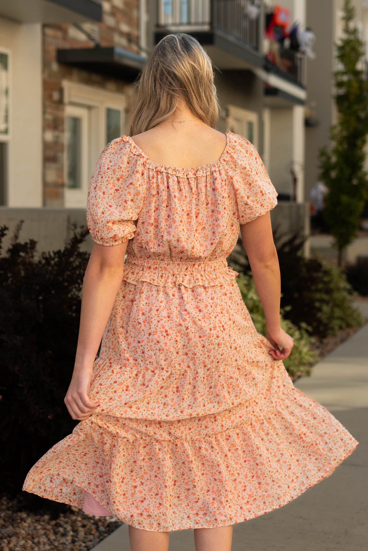 Back view of a salmon floral dress