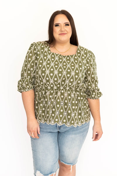 Front view of a plus size floral olive top with square neck