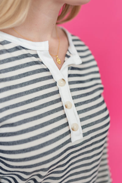 Button detail on a navy striped top