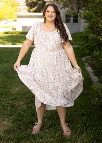 Front view of a plus size cream floral dress