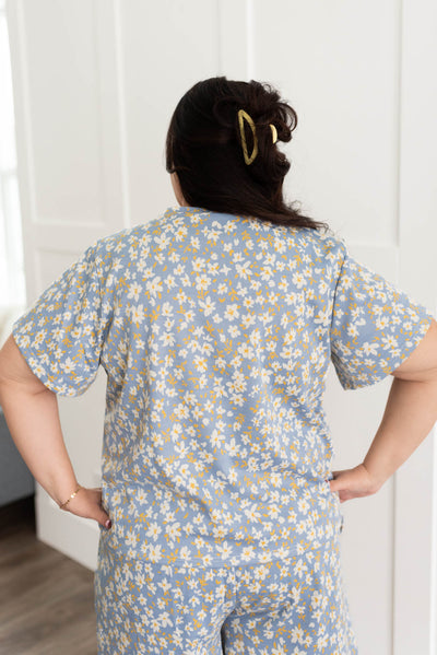 Back view of a plus size blue floral top