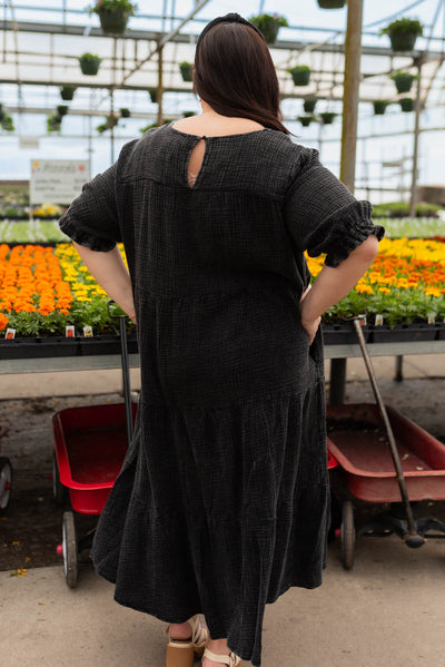 Back view of the plus size black washed tiered dress