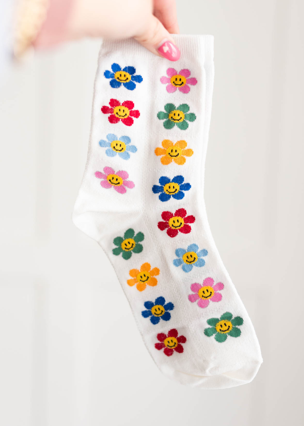 White colored flower socks with smiley faces