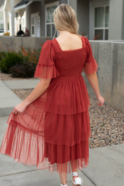 Back view of the rust ruffle mesh dress