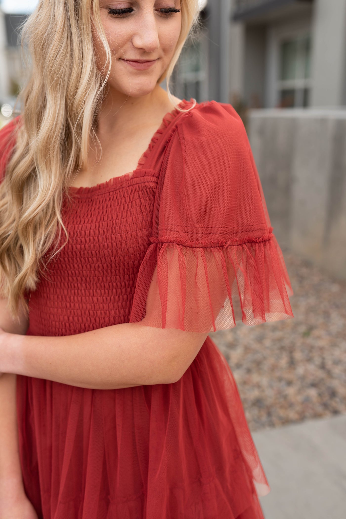 Sleeve view of the rust ruffle mesh dress