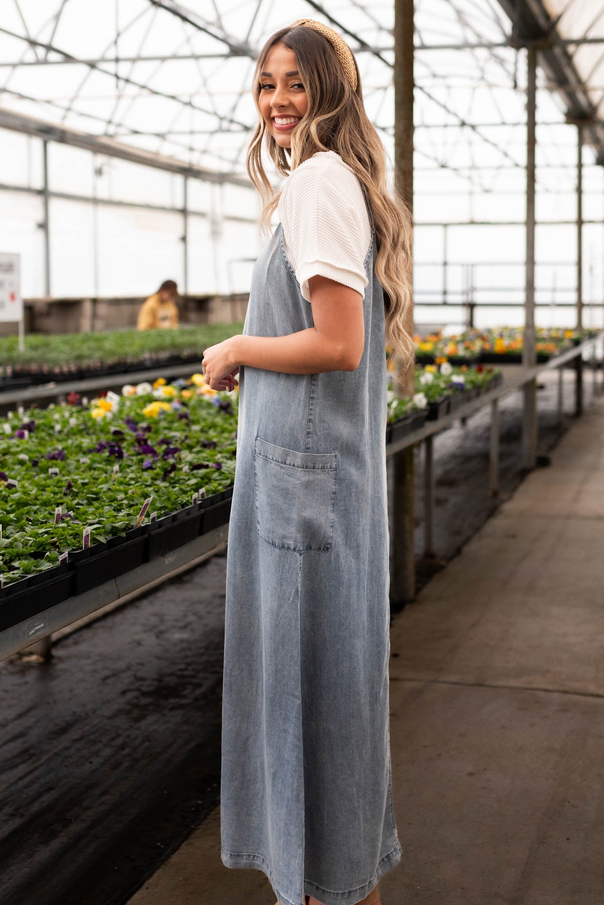 Side view of the denim blue overall dress