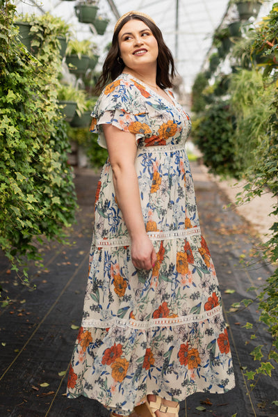 Side view of the plus size cream floral tiered dress