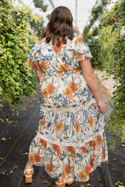 Back view of the plus size cream floral tiered dress