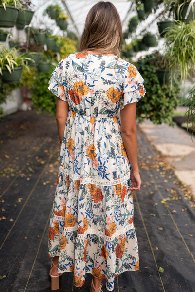 Back view of the cream floral tiered dress