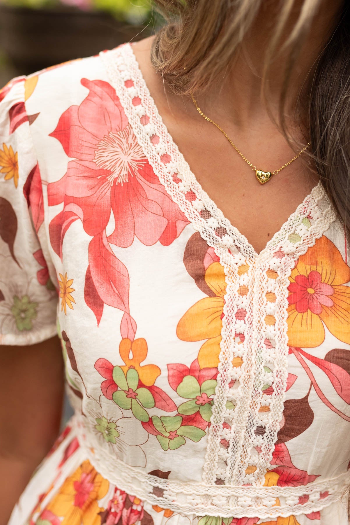 Close up of the floral pattern and lace on the red multi floral tiered dress