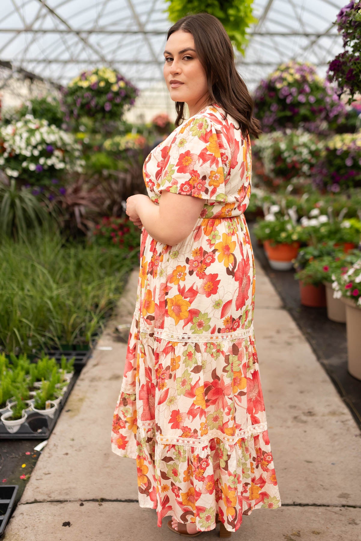 Side view of the plus size red multi floral tiered dress
