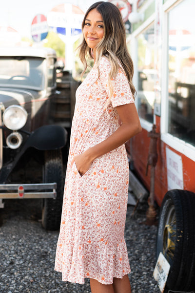 Side view of a taupe floral dress