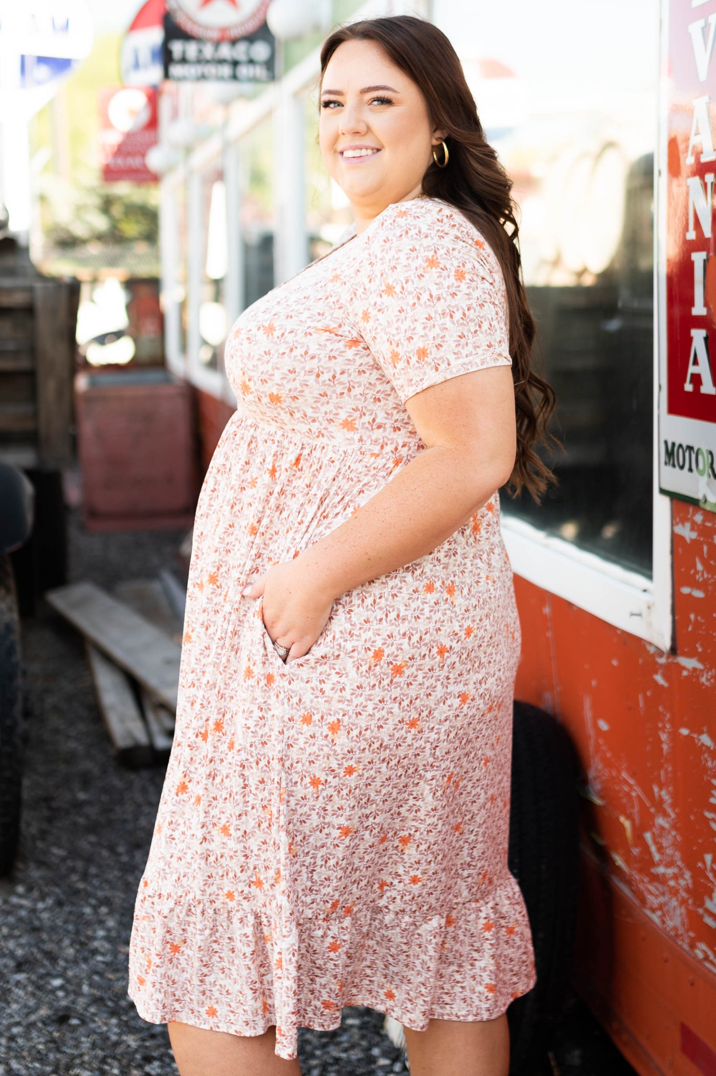 Side view of a plus size taupe floral dress