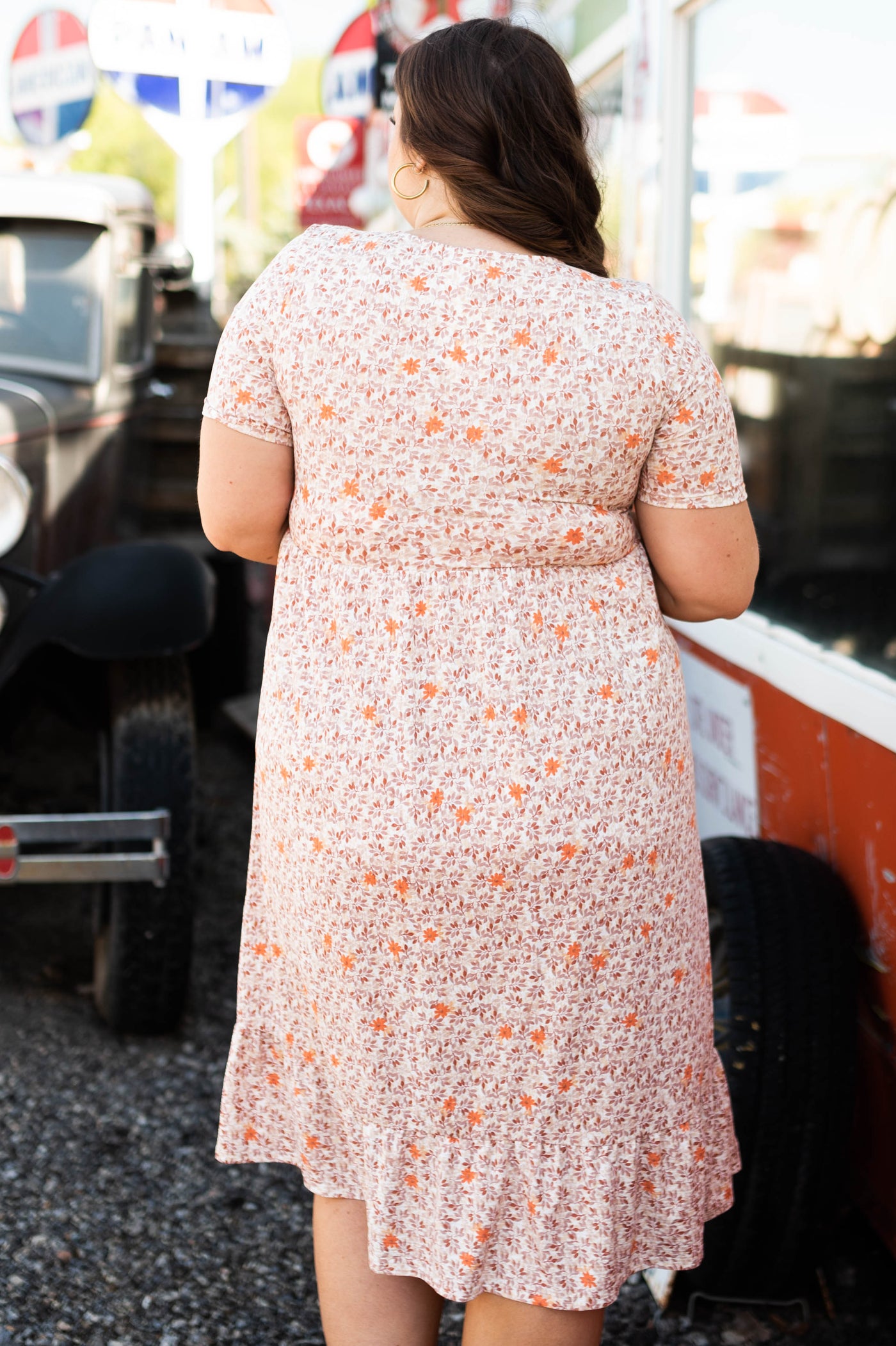 Back view of a plus size taupe floral dress