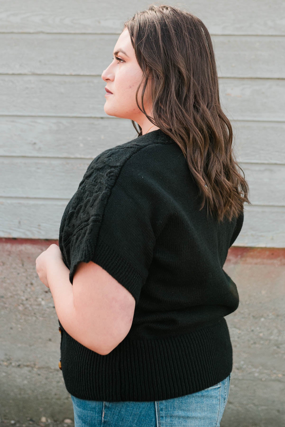 Side view of the plus size black knit cardigan